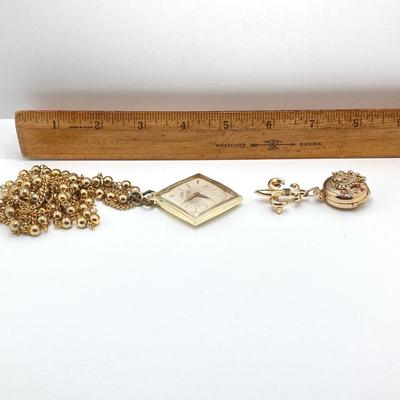 LOT 311: Vintage Jewelry - Larex Swiss Wind-up Necklace Watch, Coro Locket Brooch / Pin and Earrings