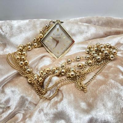 LOT 311: Vintage Jewelry - Larex Swiss Wind-up Necklace Watch, Coro Locket Brooch / Pin and Earrings