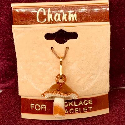 Lot 298: Gold-tone Charm Holder with 23” Chain and Unmarked and 12k GF Charms