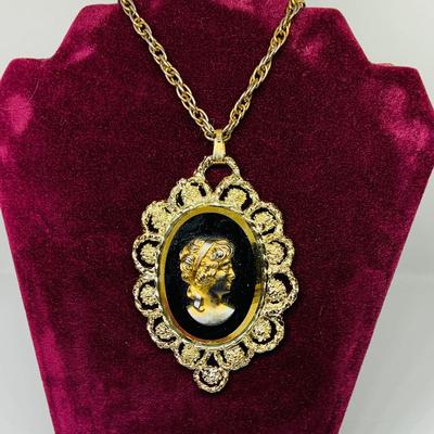 Lot 302: Collection of Vintage Cameos - 3” Pendant on a 24” Chain, 7. 1/2” Bracelet and a 2” Mother of Pearl Clip