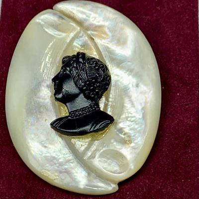 Lot 302: Collection of Vintage Cameos - 3” Pendant on a 24” Chain, 7. 1/2” Bracelet and a 2” Mother of Pearl Clip