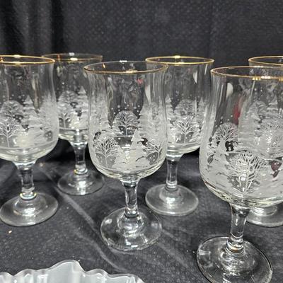 Christmas dinnerware, and decorations, Libbey wine glasses w/Etched Trees, Glass platter with Raised Scene and more