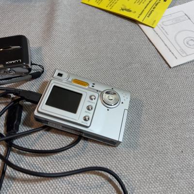 Digital Camera With Charging Cables.