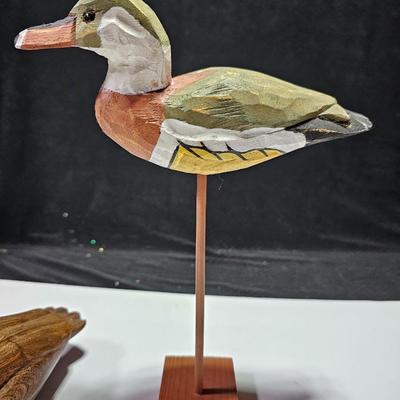 Two nice wooden ducks with brass geese and a duck on a post