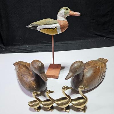 Two nice wooden ducks with brass geese and a duck on a post