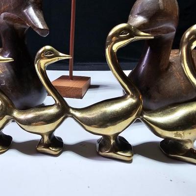 Two nice wooden ducks with brass geese and a duck on a post