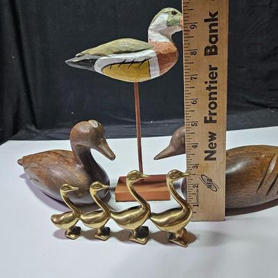 Two nice wooden ducks with brass geese and a duck on a post