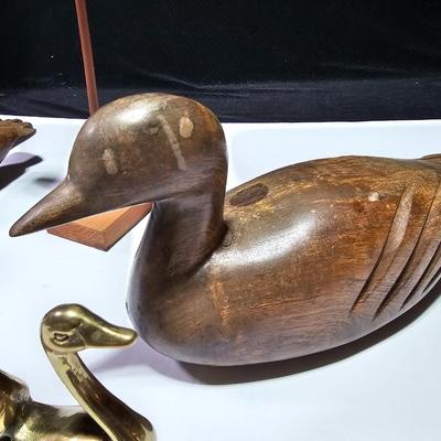 Two nice wooden ducks with brass geese and a duck on a post