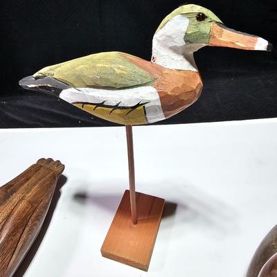 Two nice wooden ducks with brass geese and a duck on a post