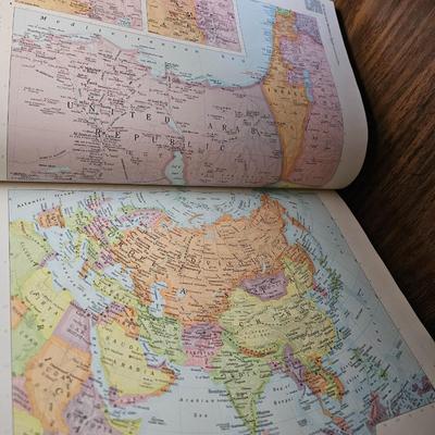 Vintage glass globe paper weight with stand and two World Atlas hardback books