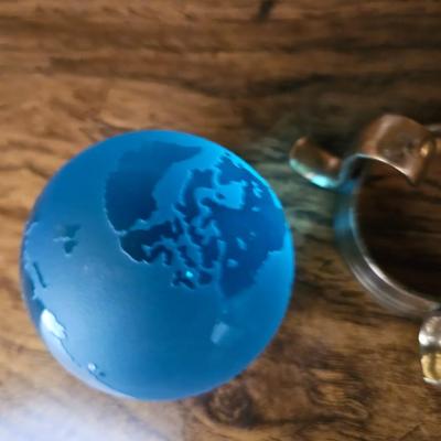 Vintage glass globe paper weight with stand and two World Atlas hardback books