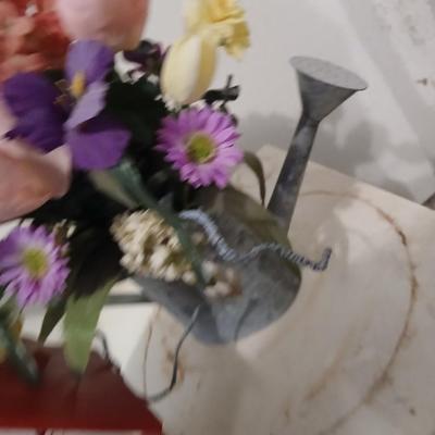 Two heavy duty plastic patio chairs, small table, galvanized watering can with flowers and a birdhouse