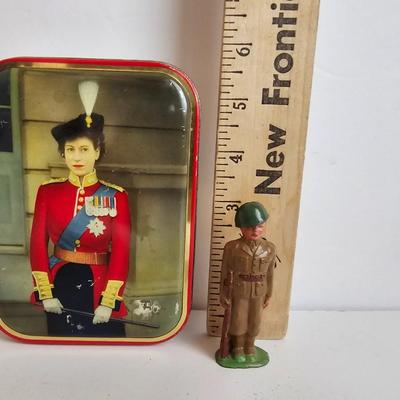 Queen Elizabeth toffee tin - made in England and a vintage lead soldier figure