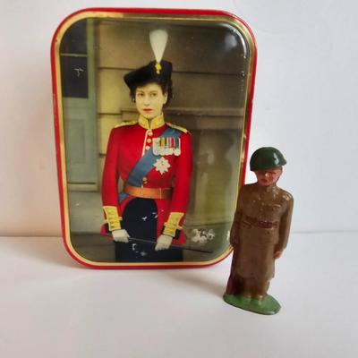 Queen Elizabeth toffee tin - made in England and a vintage lead soldier figure