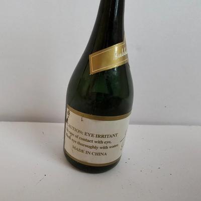 Two small tobacco pipes, champagne bubbles and a miniature metal dagger