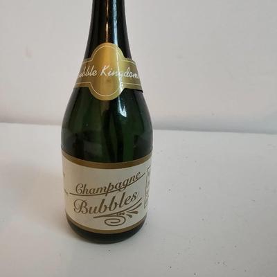 Two small tobacco pipes, champagne bubbles and a miniature metal dagger