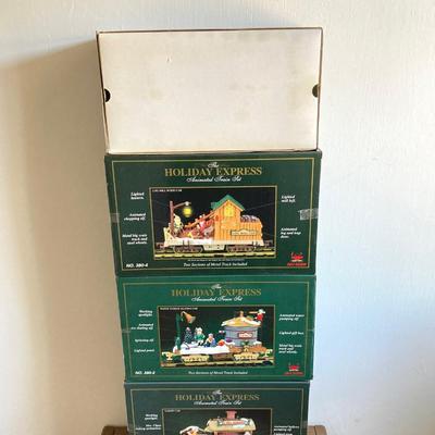 LOT 42: The Holiday Express Animated Train Set Pieces in Original Boxes (Post Office Car, Water Tanker Skating Car, Bakery Car, Log Mill...