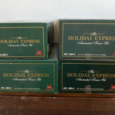 LOT 42: The Holiday Express Animated Train Set Pieces in Original Boxes (Post Office Car, Water Tanker Skating Car, Bakery Car, Log Mill...