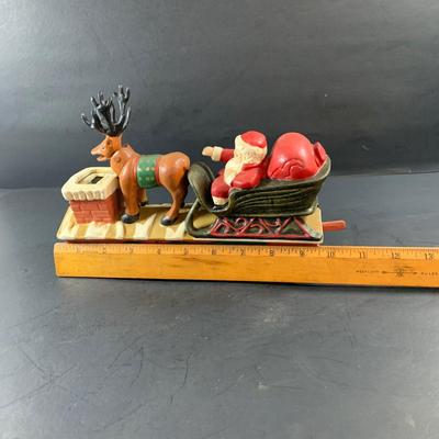 LOT 77: Vintage Cast Iron Santa and Reindeer Happy Holidays Mechanical Bank
