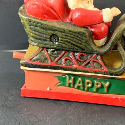 LOT 77: Vintage Cast Iron Santa and Reindeer Happy Holidays Mechanical Bank