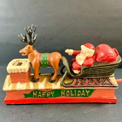 LOT 77: Vintage Cast Iron Santa and Reindeer Happy Holidays Mechanical Bank