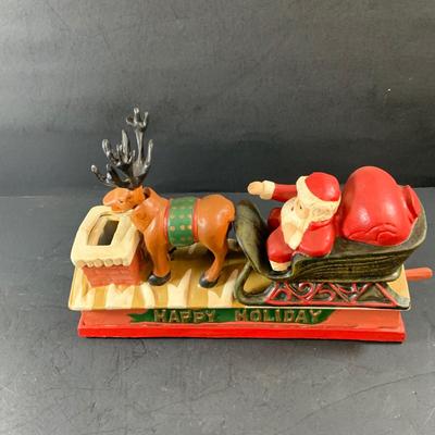 LOT 77: Vintage Cast Iron Santa and Reindeer Happy Holidays Mechanical Bank