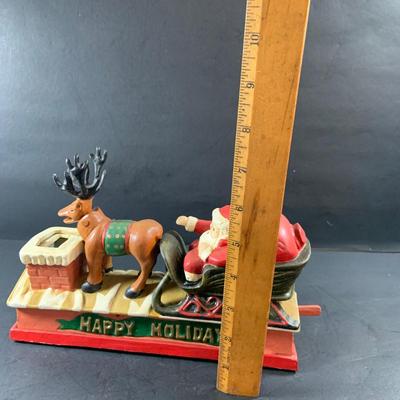 LOT 77: Vintage Cast Iron Santa and Reindeer Happy Holidays Mechanical Bank