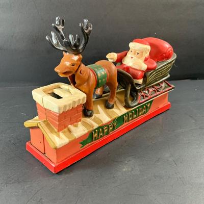 LOT 77: Vintage Cast Iron Santa and Reindeer Happy Holidays Mechanical Bank