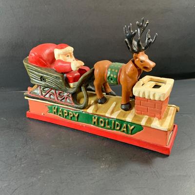 LOT 77: Vintage Cast Iron Santa and Reindeer Happy Holidays Mechanical Bank