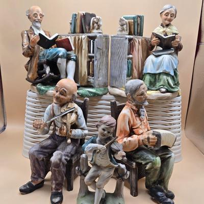 LOT 163: Norleans Japan Elderly Couple Reading Books in Rocking Chairs Bookends, & Instrument Playing Figures