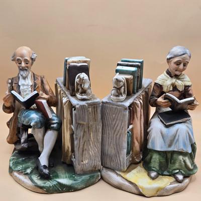 LOT 163: Norleans Japan Elderly Couple Reading Books in Rocking Chairs Bookends, & Instrument Playing Figures