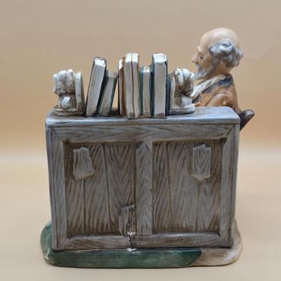 LOT 163: Norleans Japan Elderly Couple Reading Books in Rocking Chairs Bookends, & Instrument Playing Figures