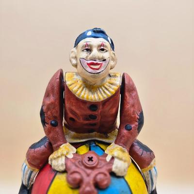 LOT 170: " Spinning Acrobat Clown on Globe" Cast Iron Mechanical Bank