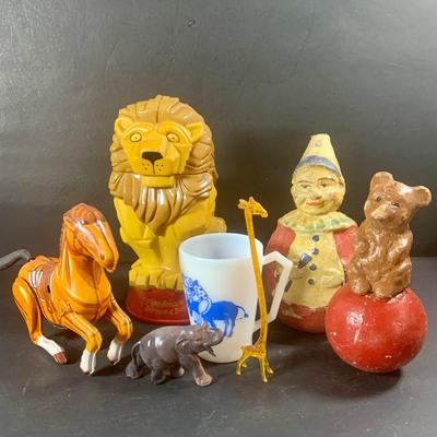 LOT 199: Circus Collection Including a Vintage Rolly Polly Clown, Bear on a Ball, Tin Toy Horse, Ringling Bros Lion Mug, Milk Glass Clown...