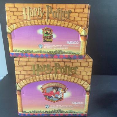 LOT 201: Harry Potter Collection Including Books, Enesco Plaques, Mattel Hedwig Toy, and Story Teller Figurines