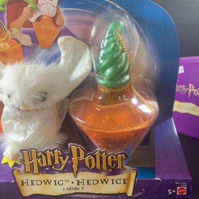 LOT 201: Harry Potter Collection Including Books, Enesco Plaques, Mattel Hedwig Toy, and Story Teller Figurines