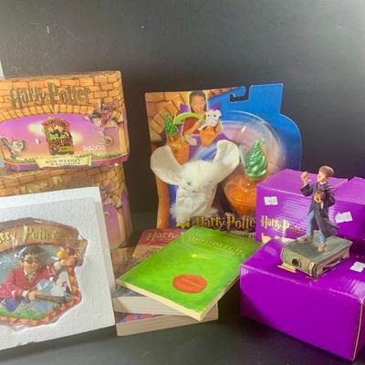 LOT 201: Harry Potter Collection Including Books, Enesco Plaques, Mattel Hedwig Toy, and Story Teller Figurines