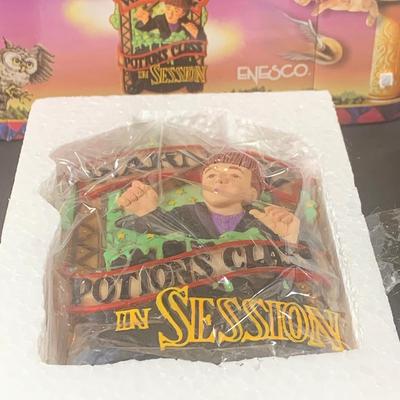 LOT 201: Harry Potter Collection Including Books, Enesco Plaques, Mattel Hedwig Toy, and Story Teller Figurines