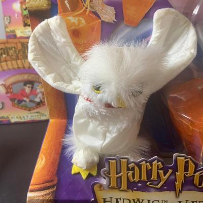 LOT 201: Harry Potter Collection Including Books, Enesco Plaques, Mattel Hedwig Toy, and Story Teller Figurines