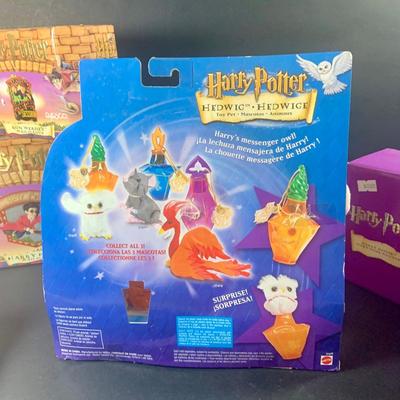 LOT 201: Harry Potter Collection Including Books, Enesco Plaques, Mattel Hedwig Toy, and Story Teller Figurines