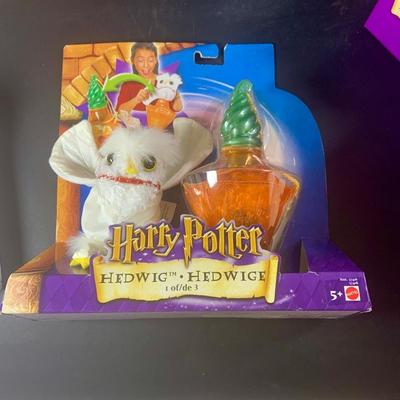 LOT 201: Harry Potter Collection Including Books, Enesco Plaques, Mattel Hedwig Toy, and Story Teller Figurines