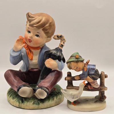 LOT 272: Enesco Boy Figure with Umbrella & Vintage Goebel HUMMEL Figure of Boy on Fence