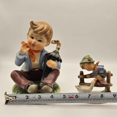LOT 272: Enesco Boy Figure with Umbrella & Vintage Goebel HUMMEL Figure of Boy on Fence