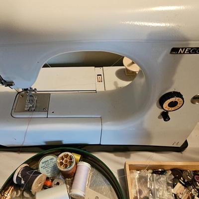 Vintage NECHI Sewing machine with sewing items and fabric