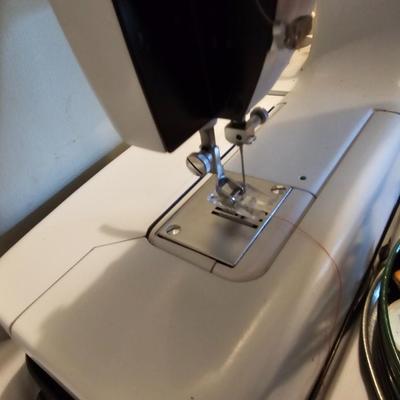 Vintage NECHI Sewing machine with sewing items and fabric