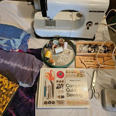 Vintage NECHI Sewing machine with sewing items and fabric