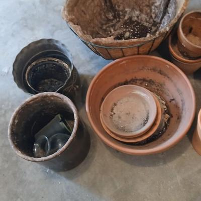 Hanging flowerpots with an assortment of other pots