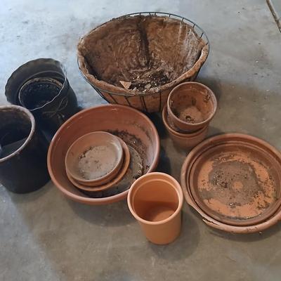 Hanging flowerpots with an assortment of other pots