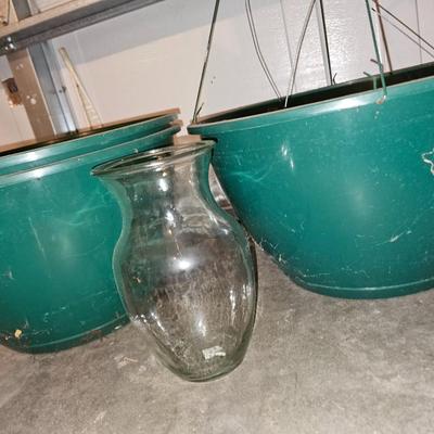 Hanging flowerpots with an assortment of other pots