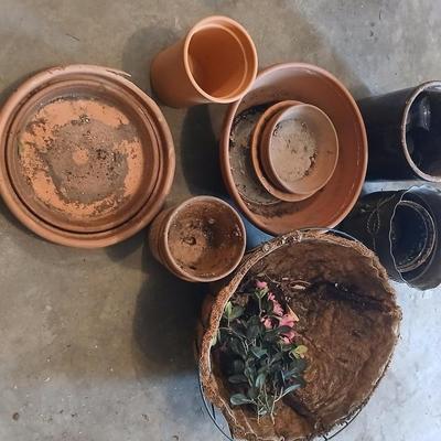 Hanging flowerpots with an assortment of other pots